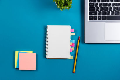 Office table desk with set of colorful supplies, white blank